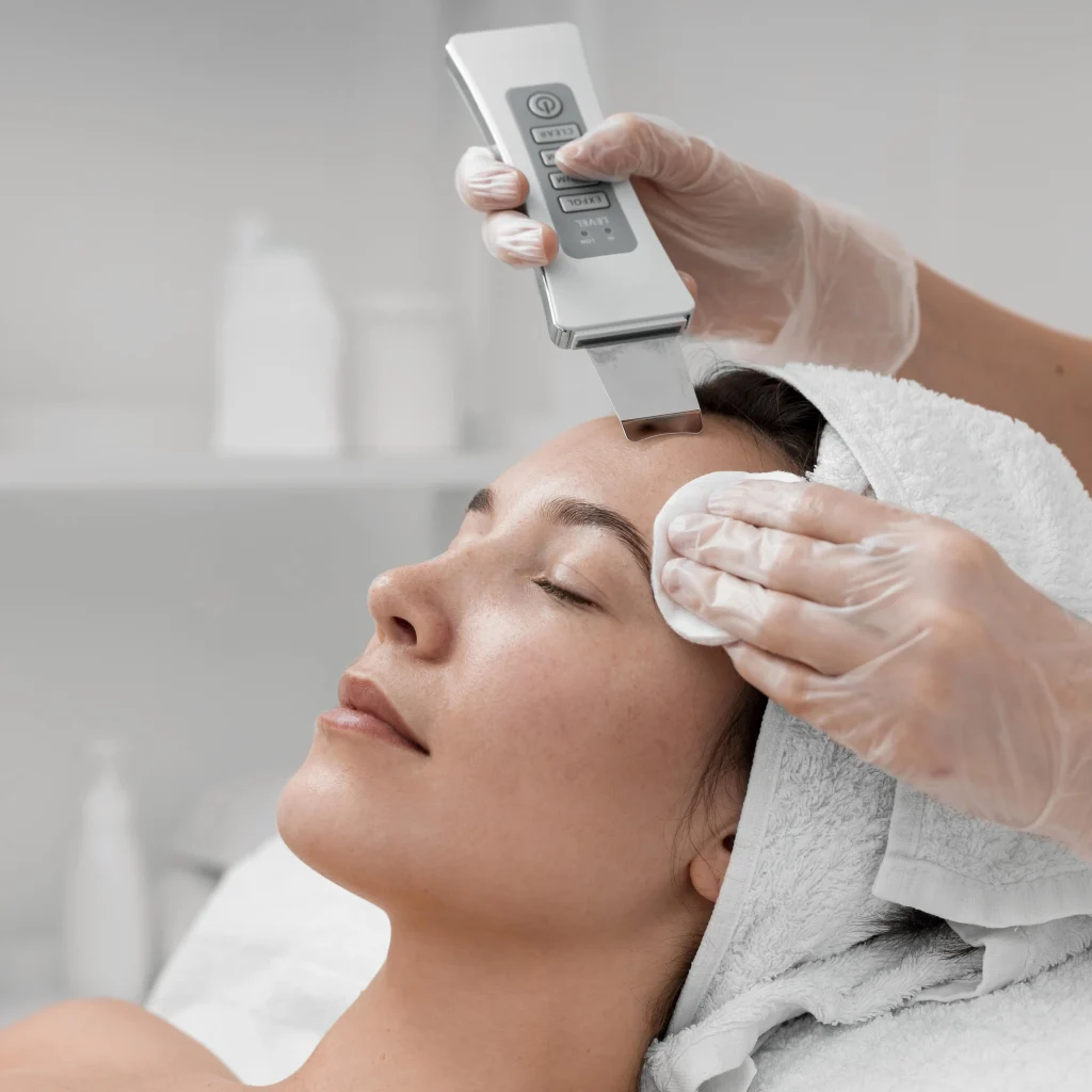 Beautician doing face beauty routine female by Whimsy Aesthetic Clinic